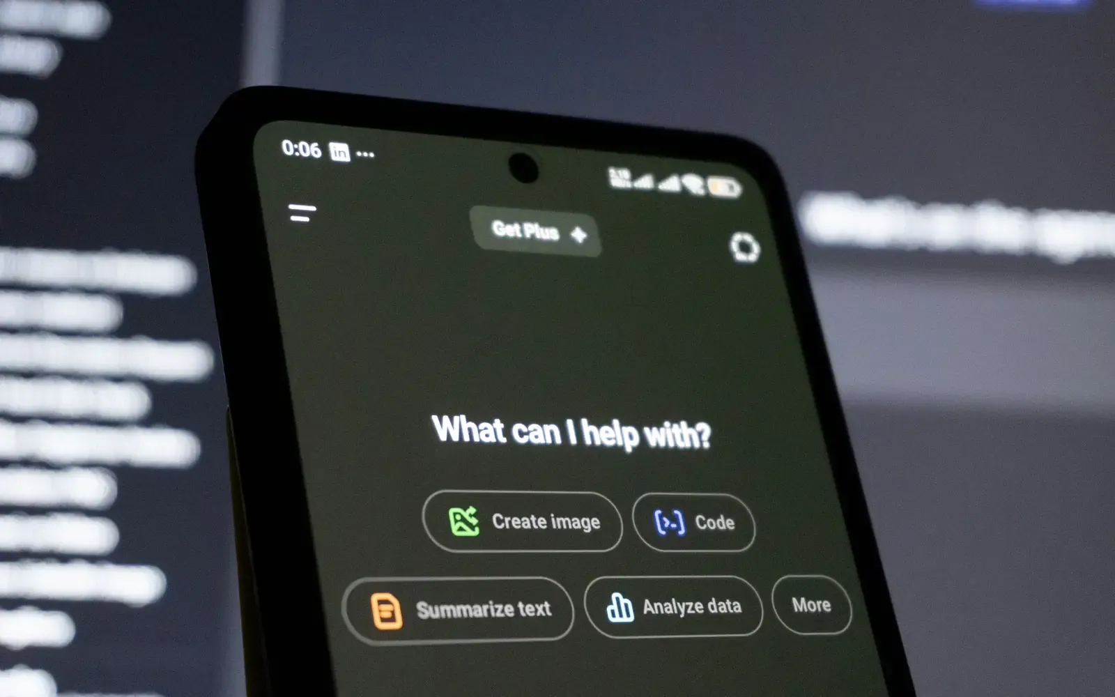 Phone showing an AI assistant chat screen asking what it can help with